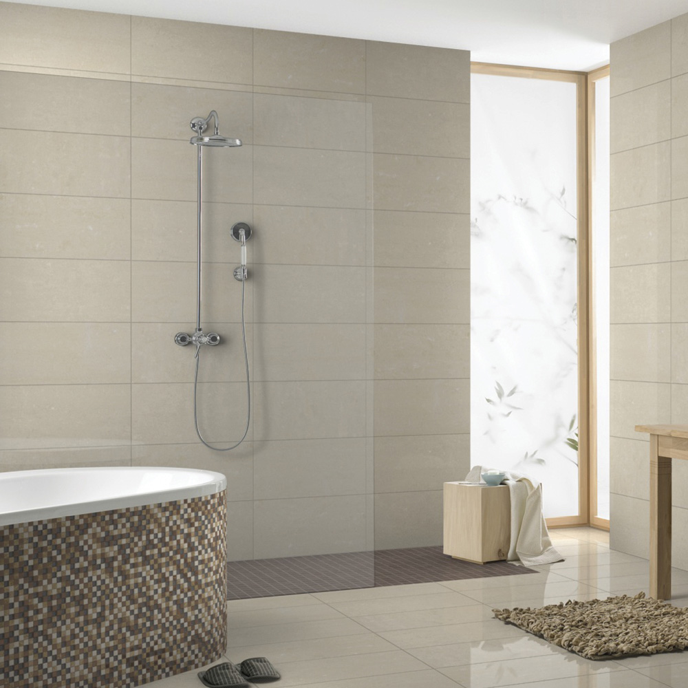 Eagle 600x300 cream tile in a open plan bathroom with walk in shower enclosure and mosaic tiled bath panel