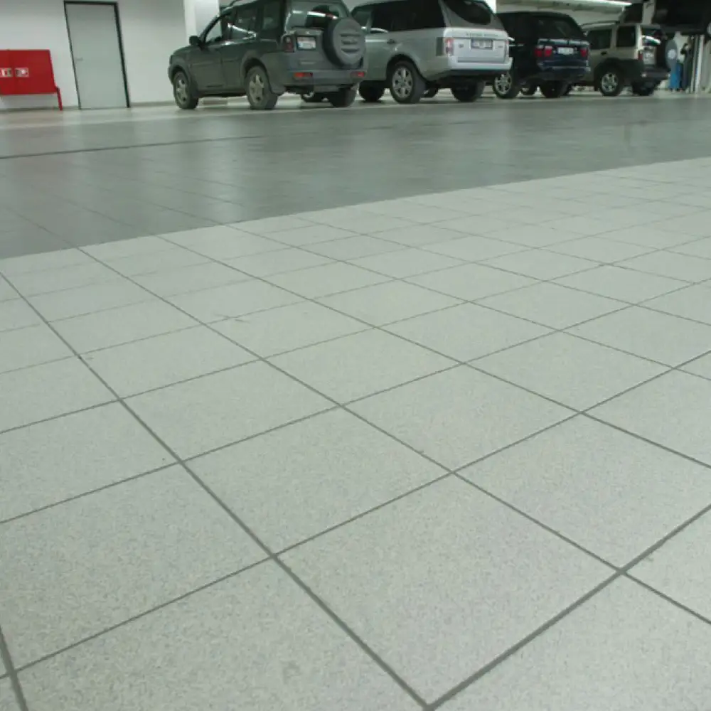Arkitect dotti Dark Grey floor tile 300x300mm on a car showroom floor