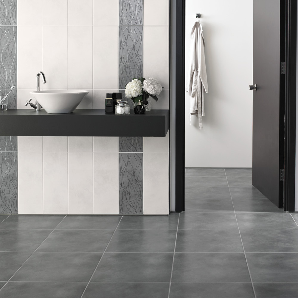 Bloom anthracite porcelain floor tile in a large bathroom with complimeting feature and white wall tiles behind a wall hung sunk