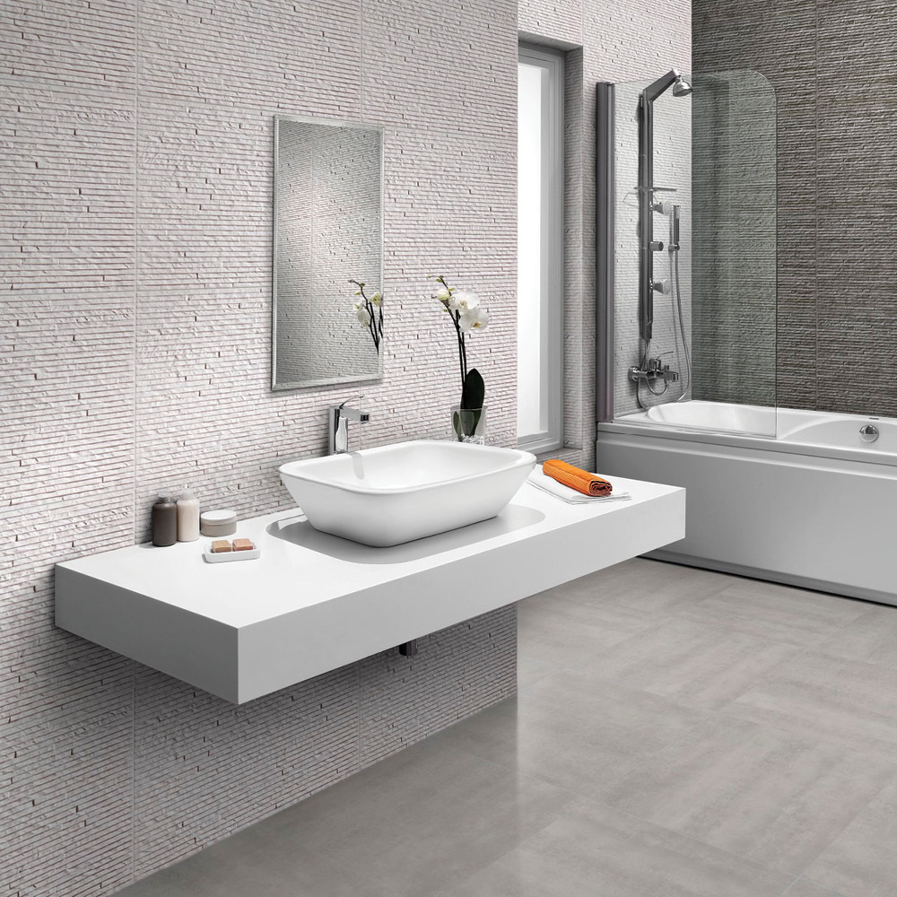 Montecarlo white splitface tile in a bathroom with accenting montecarlo grey tile on a feature wall behind a rectangular bath