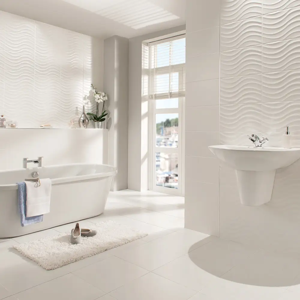 Open plan bath area highlighting a wall mounted sink with the streamline matt wave tile behind.