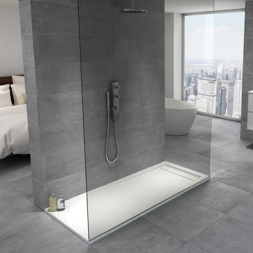 Timeless saw griss tile both features on the wall and floor of a modern walk in shower. 