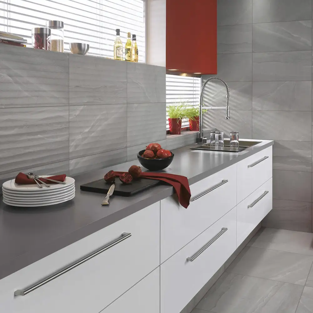 British stone grey ceramic décor tile with matching wall and floor tiles in a modern gloss white with grey worktop kitchen