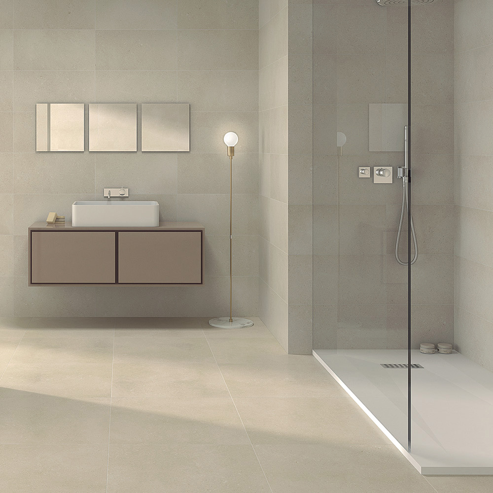 Sintesis Marfil tile in a open plan bathroom with walk in shower enclosure and wall hung coffee coloured vanity unit