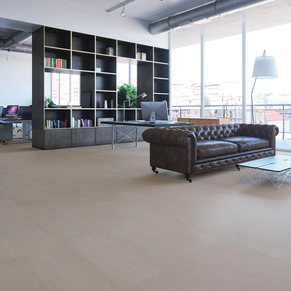 600x600 Kursaal Neatural tile in a open plan living room with dark leather sofa and a floor to ceiling storage unit