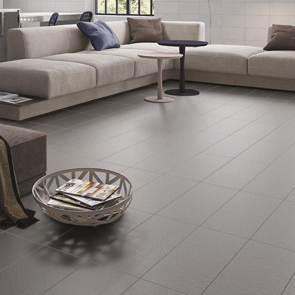 Large living area with cream sofa and the traffic anthracite tile on the floor