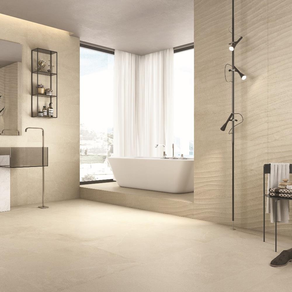 Rock beige 600x600 Porcelain tile on the floor in a large bathroom space, with modern free standing bath and taps.