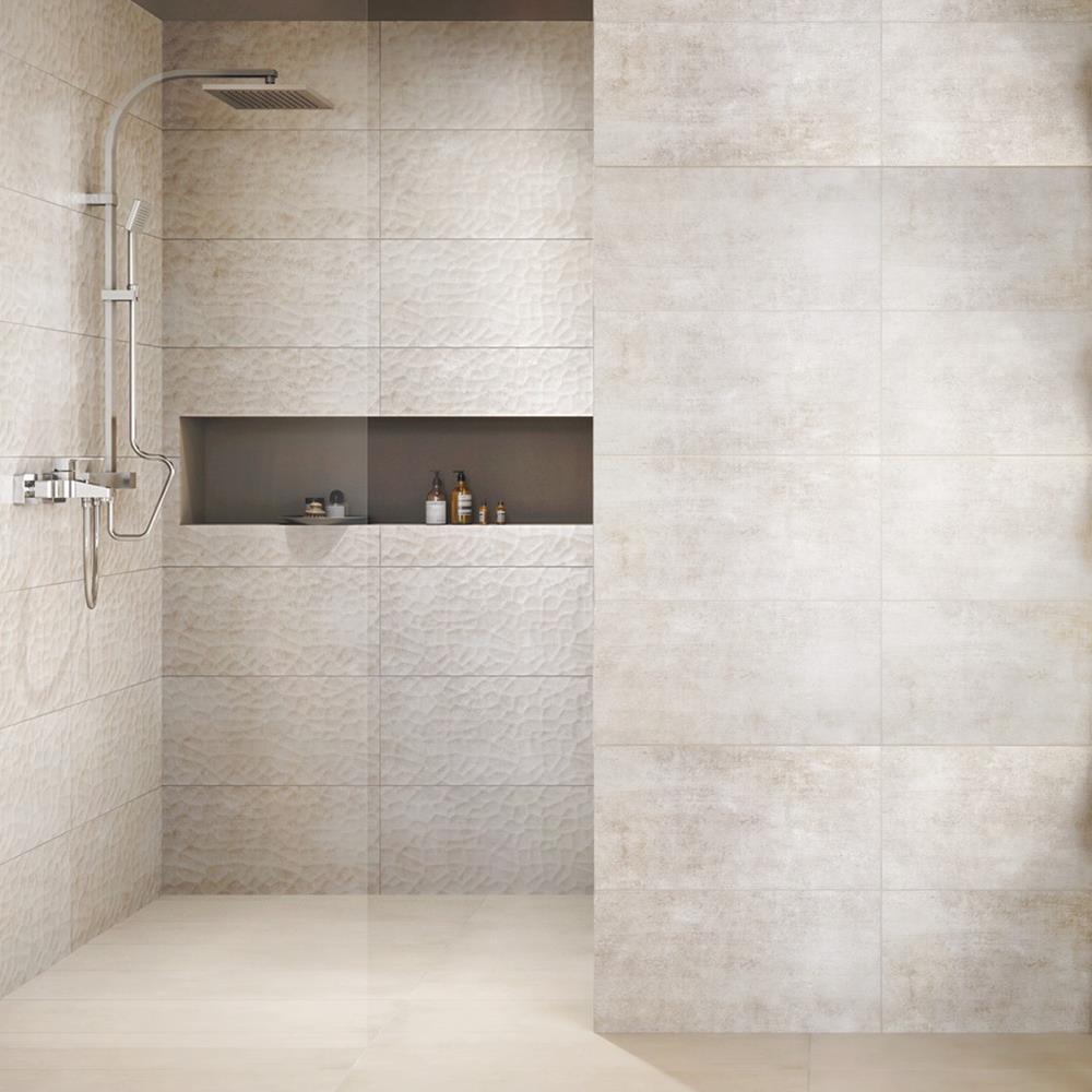 Handcrafted beige tile in a walk in shower enclosure with feature niche and wall mounted shower valves