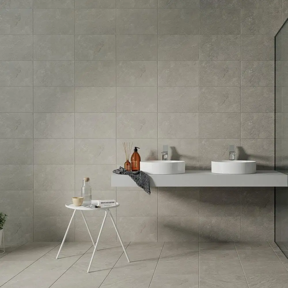 Large open bathroom space with matching quarz tiles on the wall and floor with black edged shower screen and white furnishings