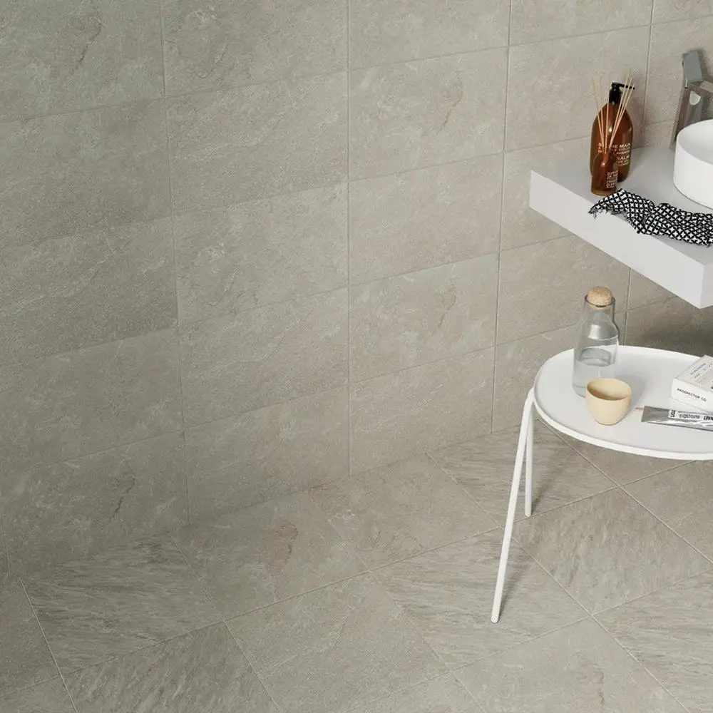 Quarz light grey tile with matching wall tiles in a open space with white furnishings