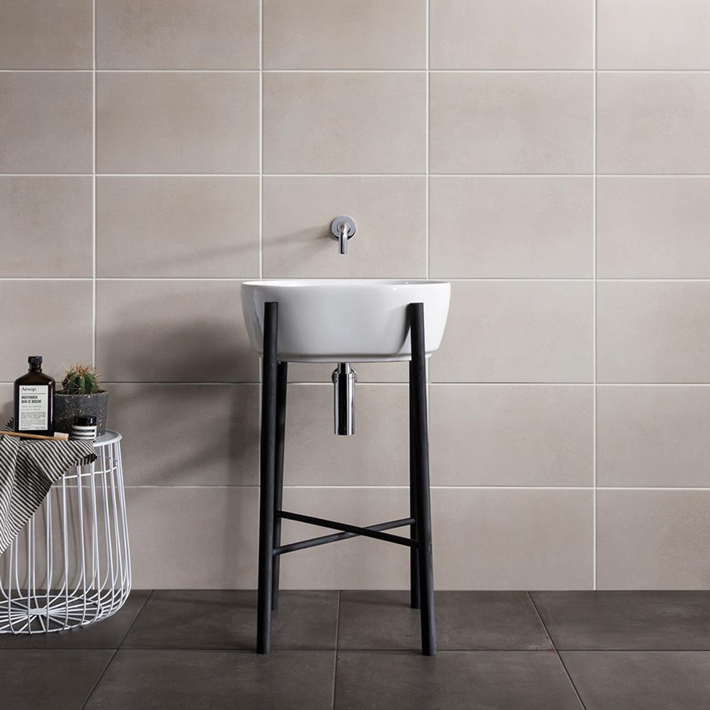 Cement Tech mini white wall tile in a bathroom with wall mounted taps and white basin with black legs