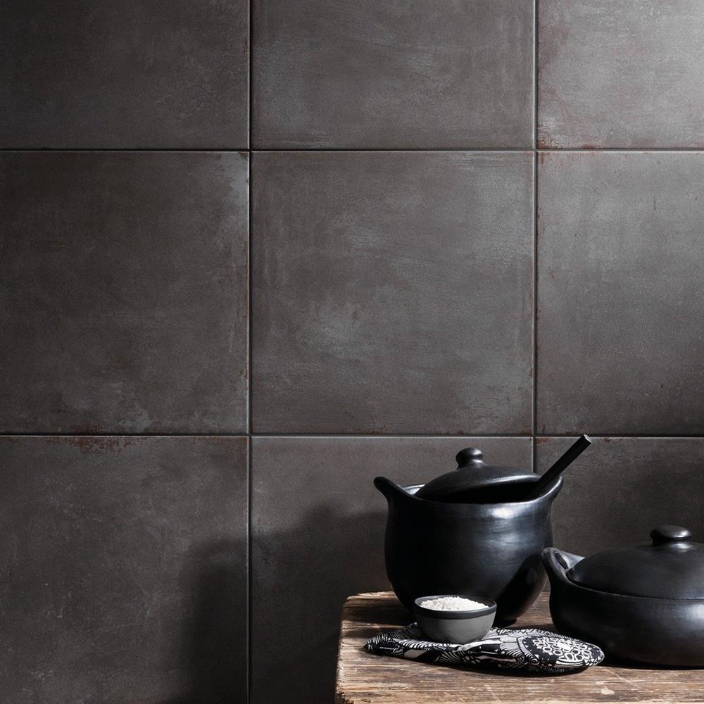 Cement Tech Mini anthracite porcelain tile being used as a feature wall in a kitchen with matching black accessories