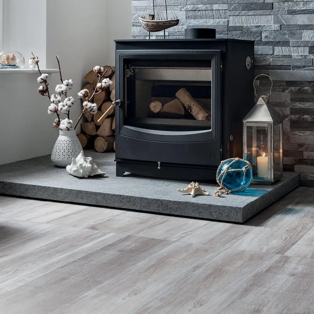 Aspenwood Mink Wood effect floor tile in a traditional floor board pattern with contrasting tiffany Dark Grey feature tile in a living room setting