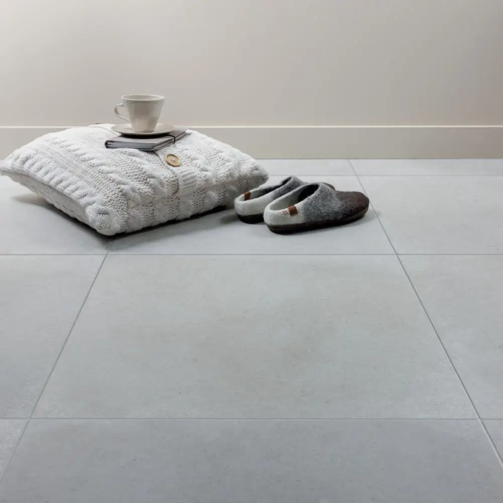 Realstone Rain almond porcelain tiles on bedroom floor with woollen accessories