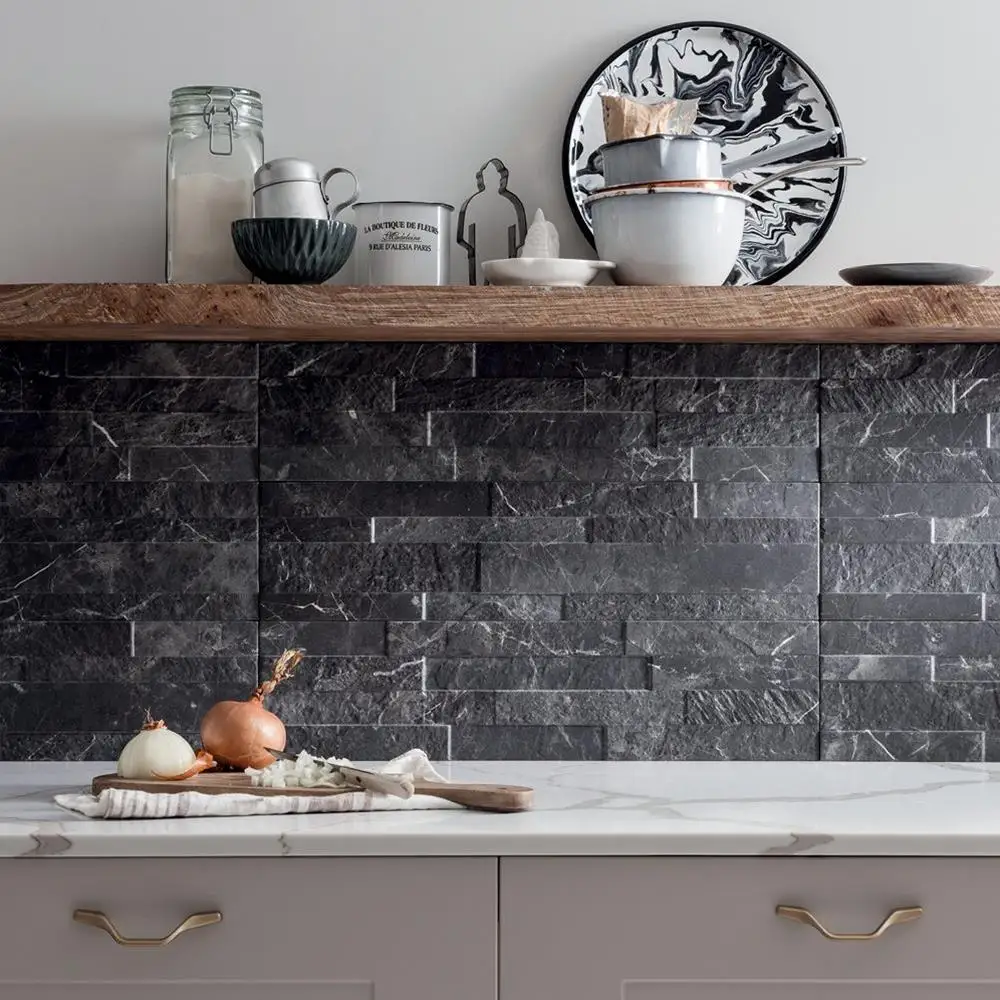 Kitchen splashback fully tiled in tiffany dark tile with floating shelves and latte coloured units.