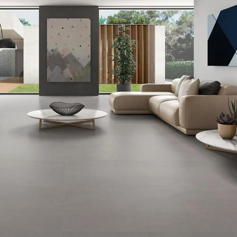 Core concrete 600x600mm tile in a large modern living room with contrasting sofas and modern wall art