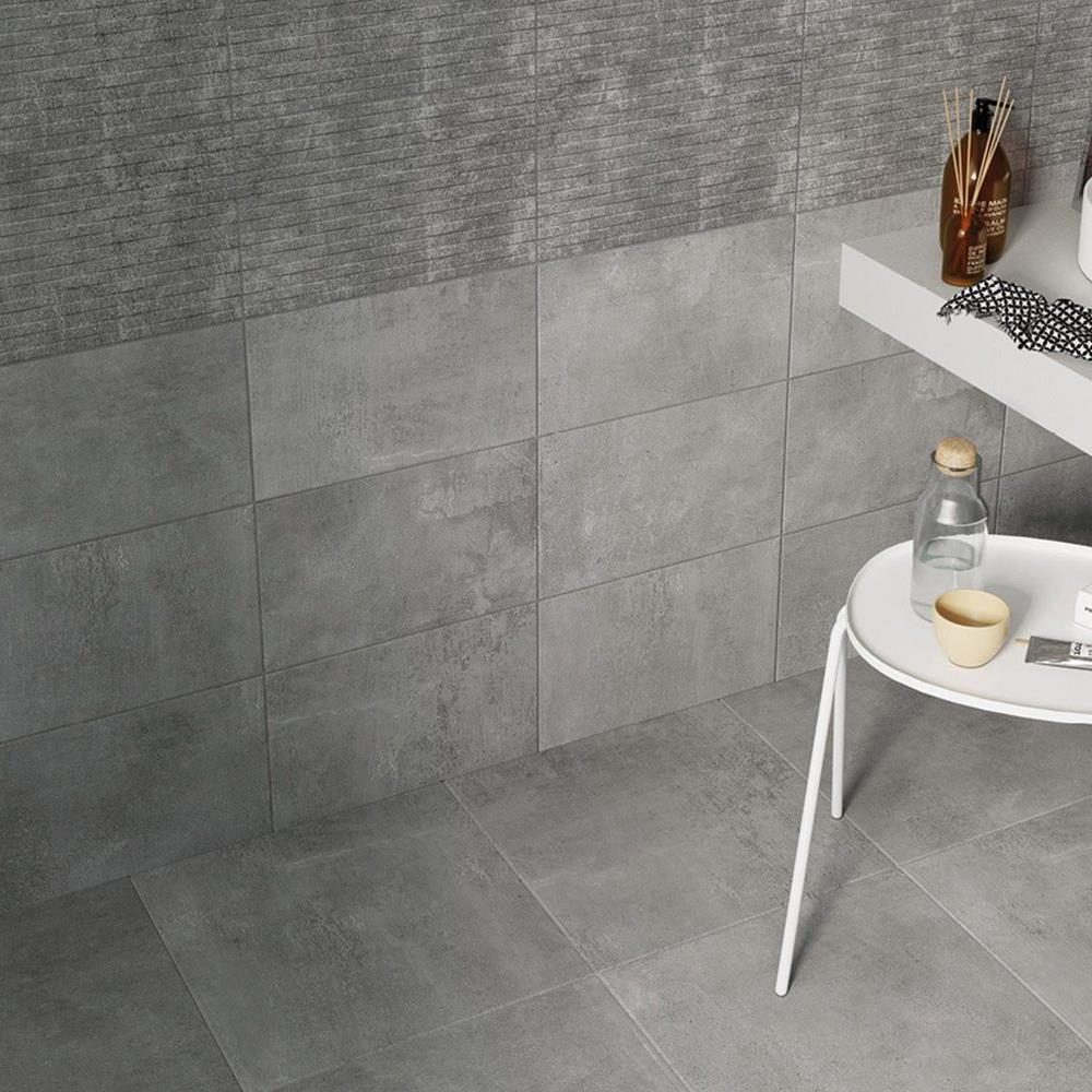 Cairn 2 smoke grey floor tile with matching plain and feature tiles in a modern bathroom setting