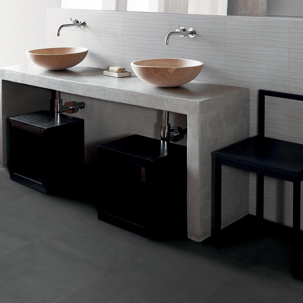 Loft anthracite tile in a modern bathroom with wall hung sink and taps next to a black stool