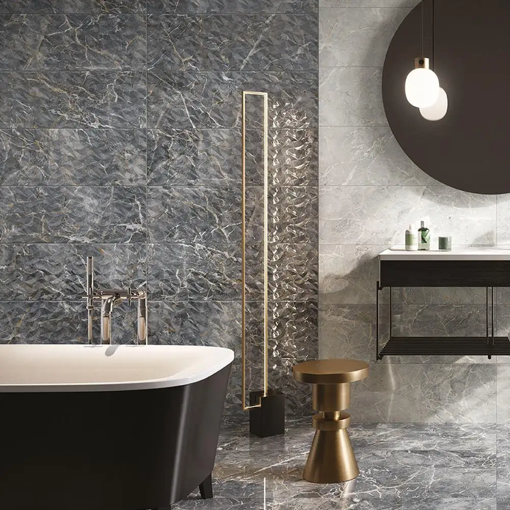 Close up of Nebula Grey Gloss marble effect décor tile on bathroom wall with chair and accessories