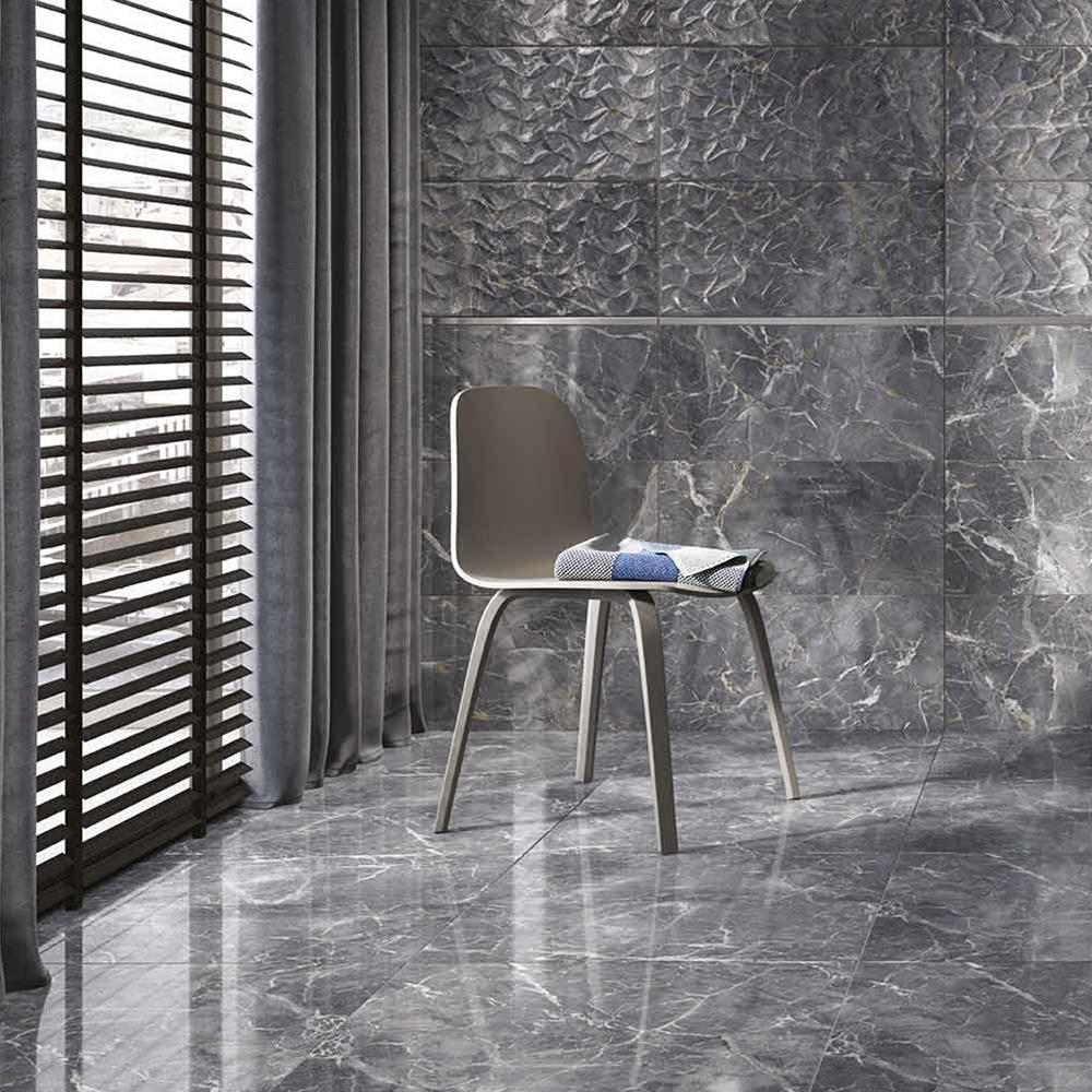 Close up of Nebula Grey semi polished marble effect wall and floor tile on contemporary bathroom floor with matching wall tiles and chair