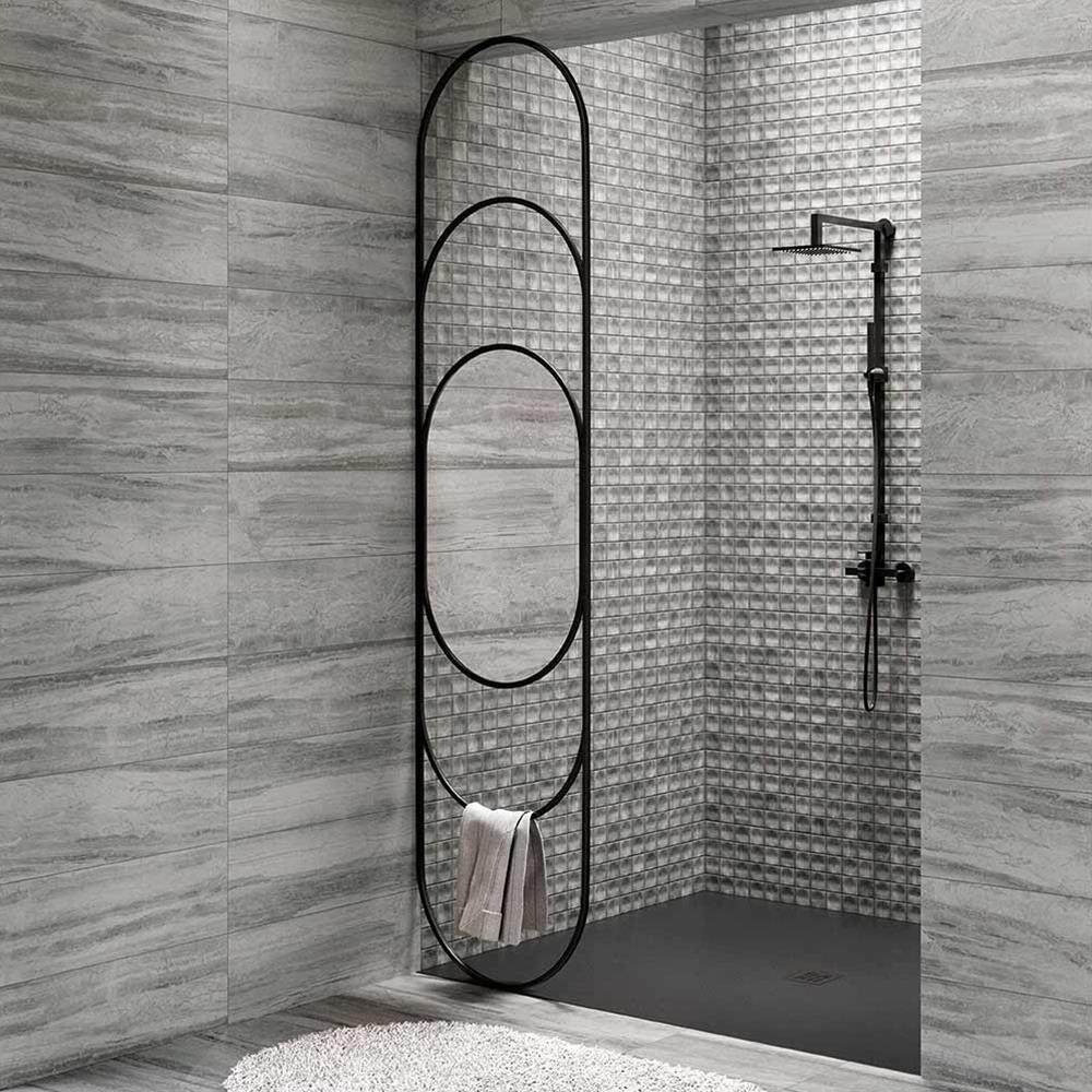 Bliss Grey stone effect tile shown on modern chic bathroom wall with shower and freestanding basin