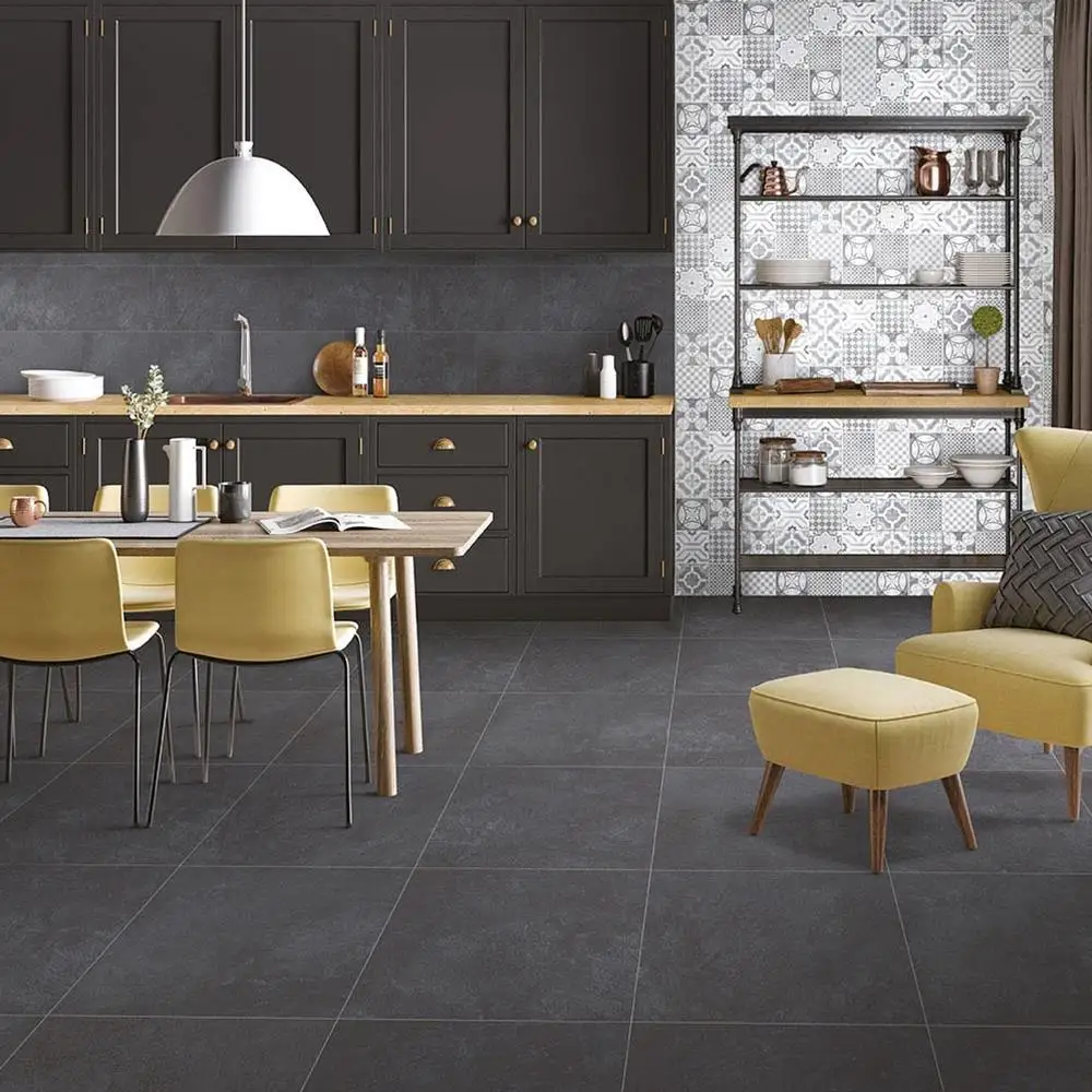 Cementine Anthracite tile on contemporary kitchen floor, with stylish accessories and patchwork décor feature wall