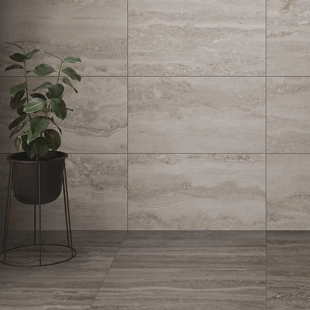 Brescia Grey Travertine Effect Tile shown on floor with plant