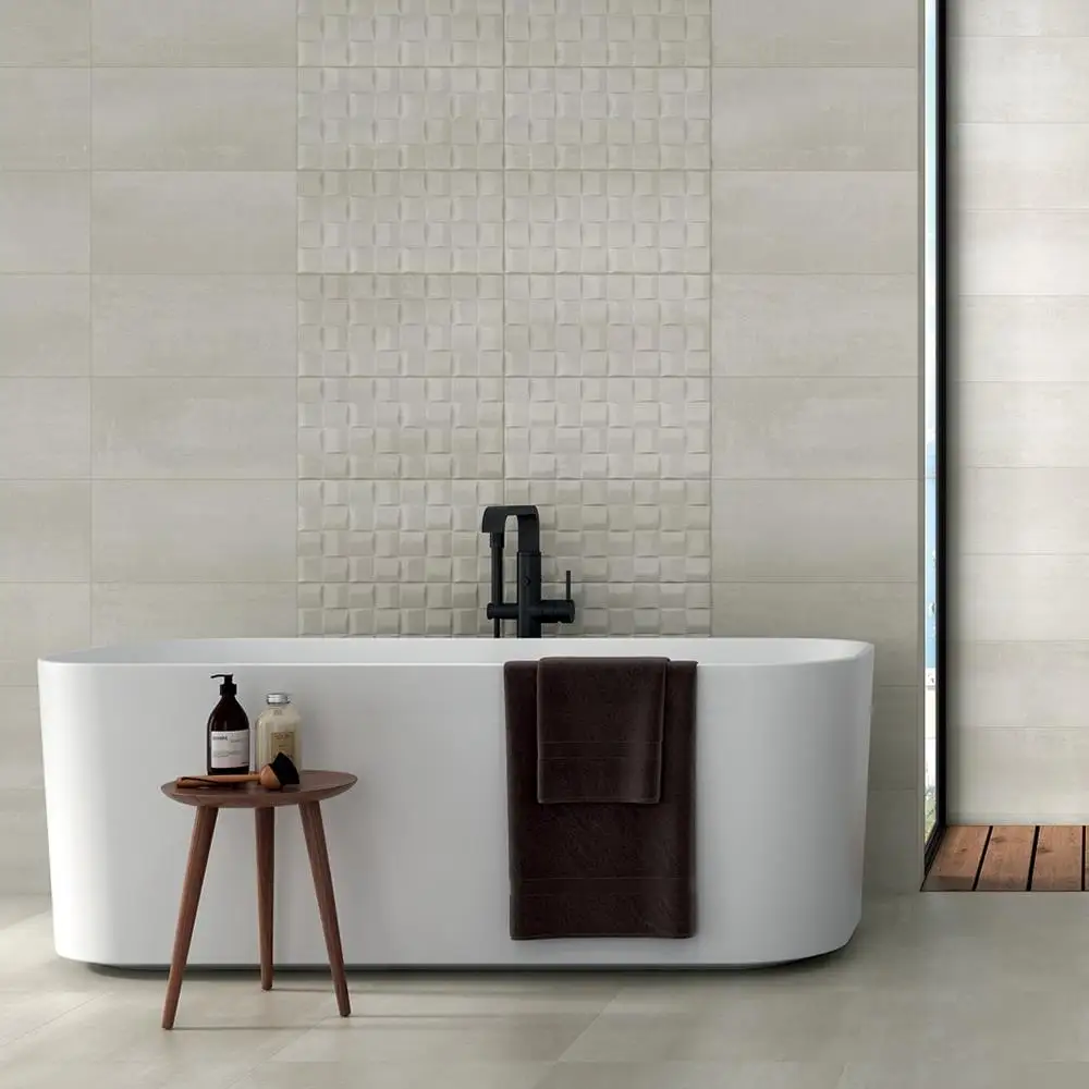 Barrington cream Art décor and plain cream tiles on bathroom wall over freestanding bath