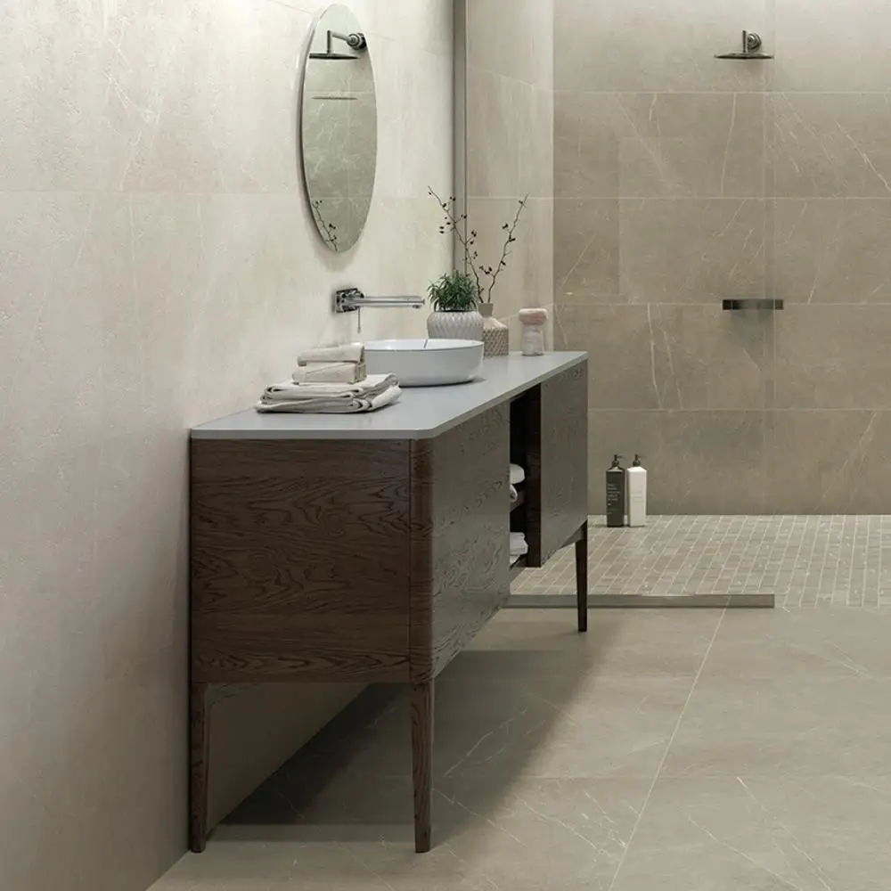 Inari crema Eco Tile in a open space with Dark oak furniture and wall mounted mirror and shower fittings