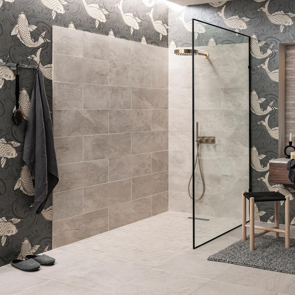 Fully tiled bathroom with the nature bone range, with tiled in bath panel and feature strips of the nature bone décor