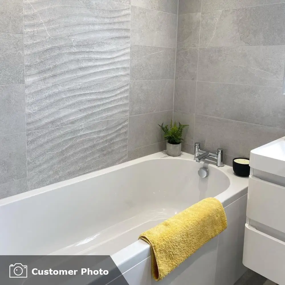 Ensuite bathroom room with white furnishings and the rock grey concept tile being used as a feature panel with plain grey on either side.