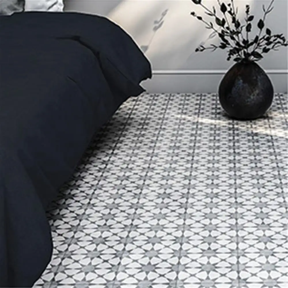 Cuban silver star tile in a modern bedroom, with contrastic black bed & Plant pot